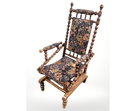 A bobbin turned rocking chair in floral upholstery 