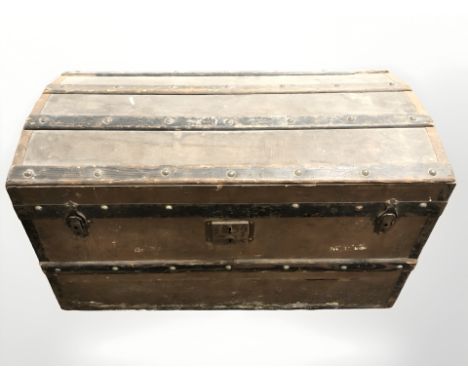 An antique canvas and wooden bound trunk, width 86 cm. CONDITION REPORT: Historic wood worm.