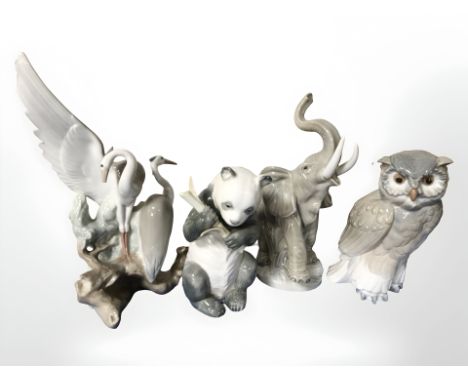 Four Nao animal figures including owl, panda, elephant and herons, tallest 26 cm.