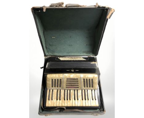 A CM accordion in case.