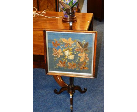 A mahogany pole screen, of small proportions, with floral embroidered panel, together with a modern Oriental table lamp with 