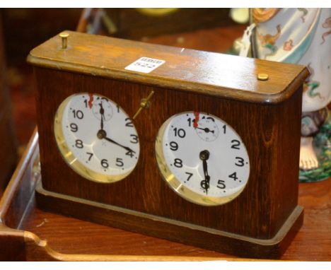 An oak cased chess clock, with Arabic dials and subsidiary seconds dials, 15cm high