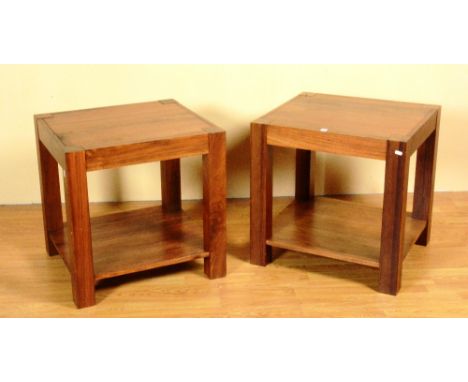 A pair of modern hardwood lamp tables, with two tiers raised on plain block supports, 62cm high x 62cm wide