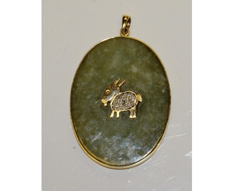 A 14ct gold and jade type pendant, with central gold goat motif to front, set with mili diamond to body, and gold Chinese cha