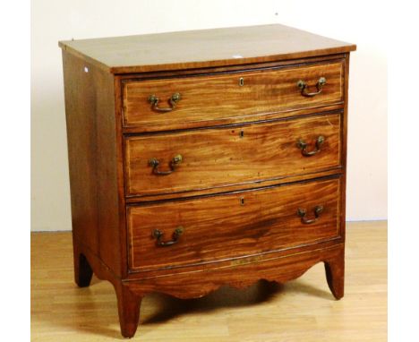 A 19th century mahogany chest of drawers, in the George III style, with three graduated drawers, raised on bracket supports, 