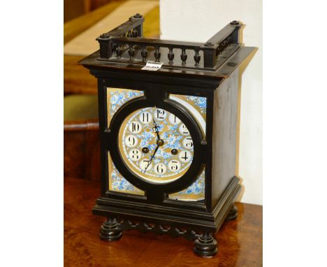 A late Victorian ebonised mantle clock, with blue and gilt foliate decorated porcelain dial, 32cm high