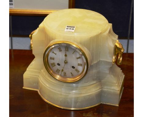 An early 20th century French onyx mantle clock, decorated with animal mask finials and ring handles, 21cm high