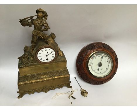 A circular aneroid barometer housed in an oak frame carved with a continuous band of flowers and foliage, marked to the dial 