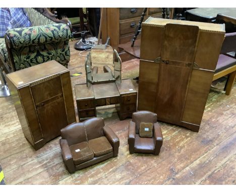 A three-piece walnut miniature bedroom suite, comprising two wardrobes and a dressing table, together with a miniature brown 