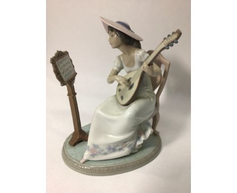 A Lladro porcelain figure of a seated lady playing guitar with music stand, 'Sweet Song No. 06408', signed to base, 21cm high