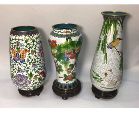 Three various large cloisonné enamel vases on stands, decorated with flowers, birds and butterflies etc. the tallest 31cm hig