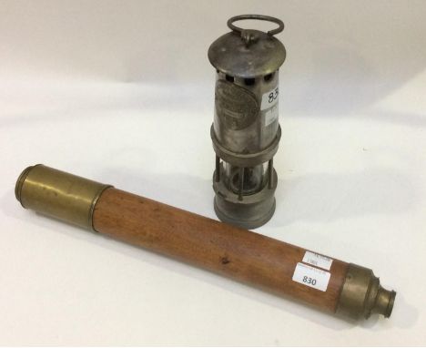 A wooden-sleeved single-drawer brass telescope, with forward sliding object lens shade and sliding front and rear lens covers