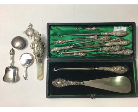 Various silver items including a rattle in the form of a cat, miniature silver-backed hand mirror, St John Ambulance Associat