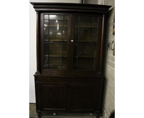 A Nelson period mahogany two door Bureau Bookcase, with bobbin turned cornice, over glazed door flanked by columns on a base 