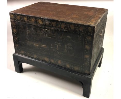 A 19th Century lacquered Chinese Trunk on Stand, decorated in the typical taste with buildings and figures etc., highlighted 