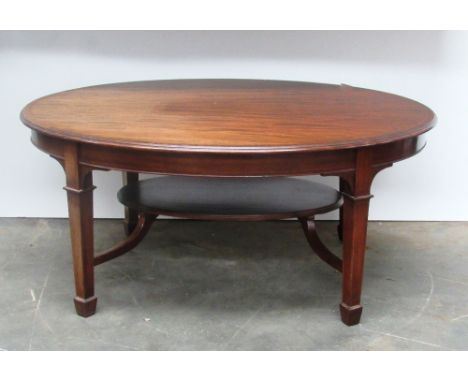 A 19th Century inlaid mahogany oval Coffee Table, with crossbanded rim raised on square tapering legs united by a stretcher s