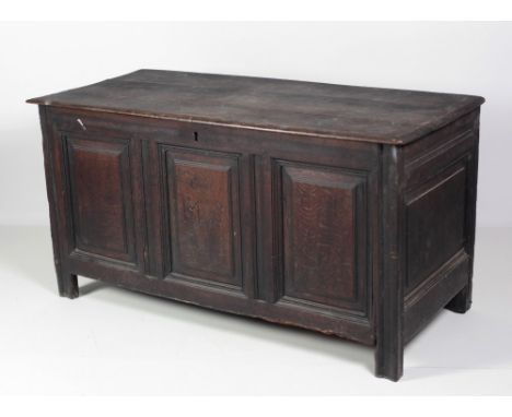 An 18th Century carved oak Coffer, the three plank lift top over panelled sides, the centre front panel with initials 'M.S.' 