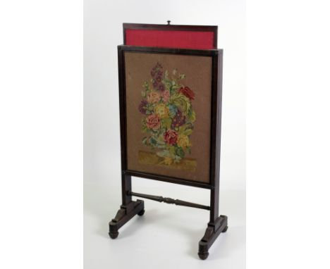 A Victorian mahogany Firescreen, with floral needlework panel on outsplayed legs. (1)