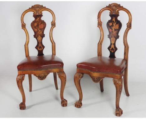A Victorian style circular pod Breakfast Table, the top profusely decorated with marquetry design, on a heavy carved tripod b