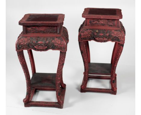 A pair of attractive large late 19th Century Chinese cinnabar Stands, with profuse decoration of dragons and flowers on a pla