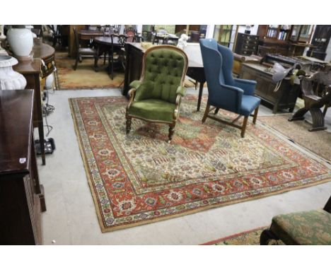 A large Oriental red ground Carpet, with large central panel and wide border with central design, 119" x 108". (1)