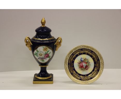 A tall attractive German Royal blue and floral decorated Urn and Cover, with gilt finial and rams head handles, approx. 46cms