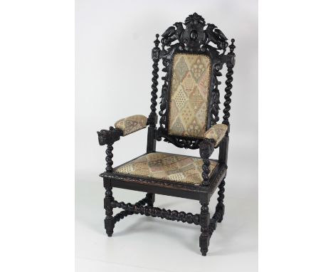 An almost matching pair of 19th Century large carved oak Cromwellian type Armchairs, each heraldic style carved back with gro