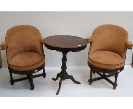 A mahogany circular tripod Occasional Table, together with two unusual swivel cream covered Tub Chairs on X frame bases. (3)