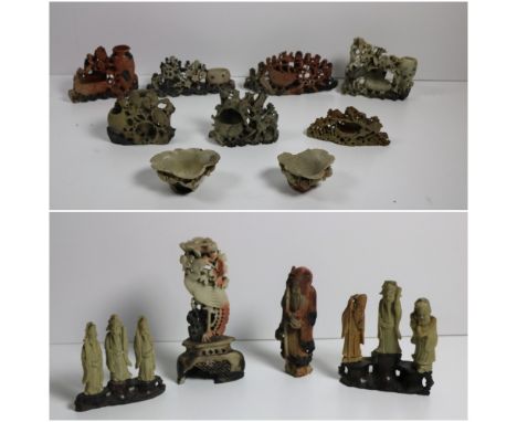 A collection of 19th Century Chinese soapstone Immortals, mounted in threes on naturalistic stands, together with a large sim