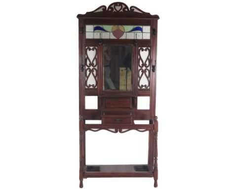 An Arts &amp; Crafts period mahogany Stick and Umbrella Stand, in the style of Voysey, with attractive stained glass panel in