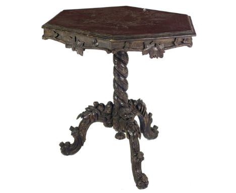 A 19th Century carved and stained oak hexagonal top Tripod Table, with carved decorated top over an apron with vine relief de