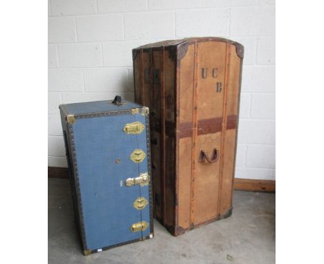 A late 19th Century tall leather bound canvas Trunk Wardrobe, with latted supports and heavy brass mounts, the interior fitte