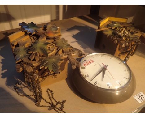 Two cuckoo clocks and a quartz wall clock