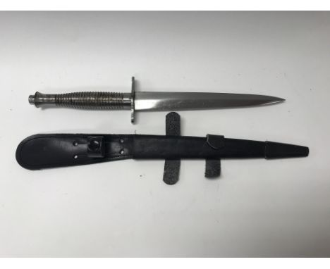 A modern commando Fairbairn Sykes fighting knife and scabbard.