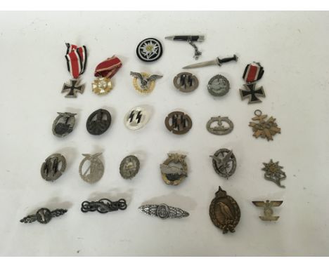 A group of German WW2 badges including SS, Iron Cross, Olympics and others.