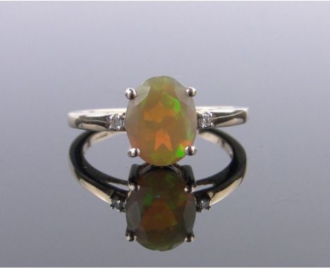 A 9ct gold Ethiopian opal set ring,opal 9mm x 7mm with small diamond set shoulders, size L.