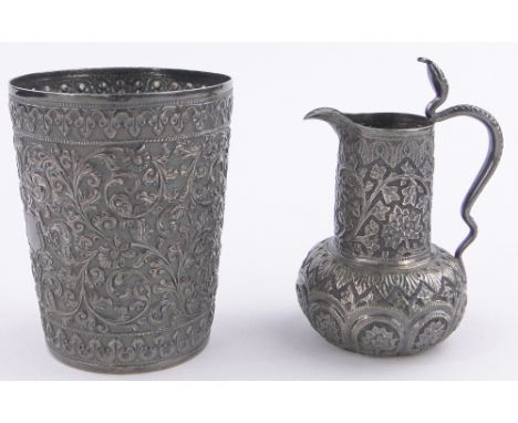 An Indian silver beaker,with relief decorated surround, height 8cm and an ornate Indian silver cream jug with cobra handle, (