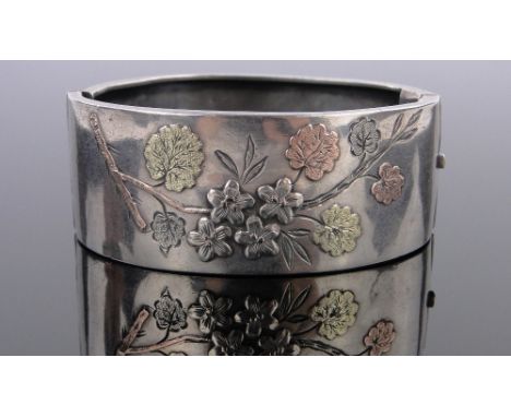 A Victorian silver and 3 colour gold hinged bangle,dated 1883.