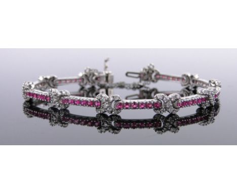 A 14ct white gold ruby and diamond set articulated bracelet,gross weight 14.5 grams.