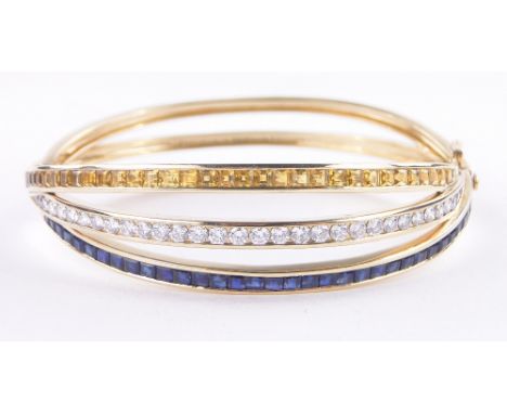 An 18ct gold triple band hinged bangle,the central band set with approx. 2cts of brilliant-cut diamonds, flanked by 2 bands o