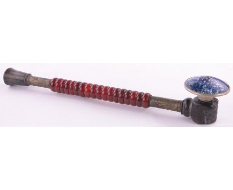 A brass mounted opium pipe with Cornelian ring stem,length 15.25".