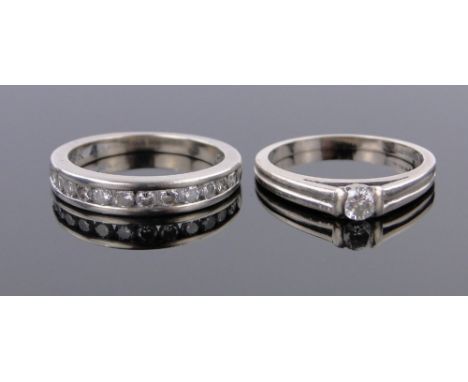 A 9ct white gold diamond set half eternity ring,and a solitaire diamond ring, (2).