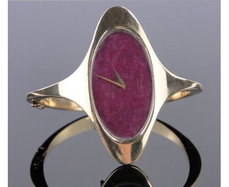 A Chopard 18ct gold bangle wristwatch,the dial formed from a sheet of polished ruby, case width 52mm, gross weight 58grams, w