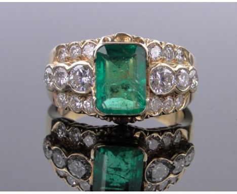 An 18ct gold emerald and diamond ring,central square-cut emerald 9mm x 6mm with diamond set shoulders, total diamond content 