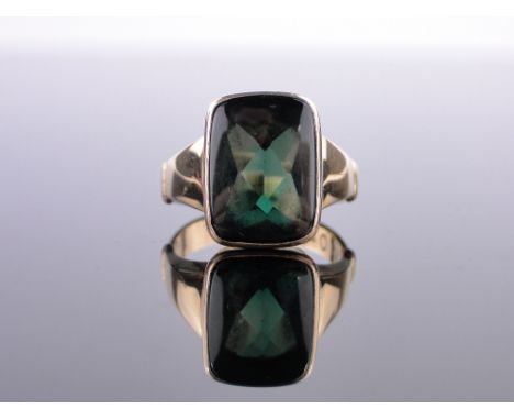 A gent's Russian green stone set gold ring,polished surface with faceted underside, various Russian hallmarks, setting height