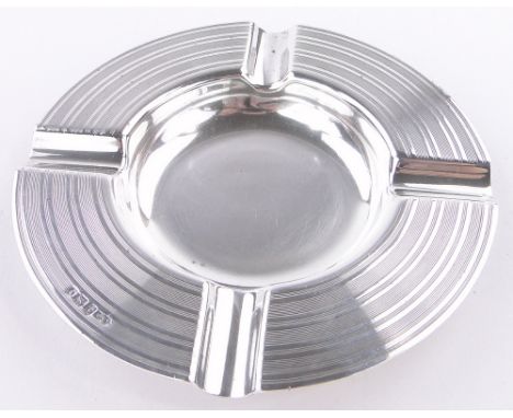 An engine turned circular silver ashtray,Birmingham 1923, 13cm across.
