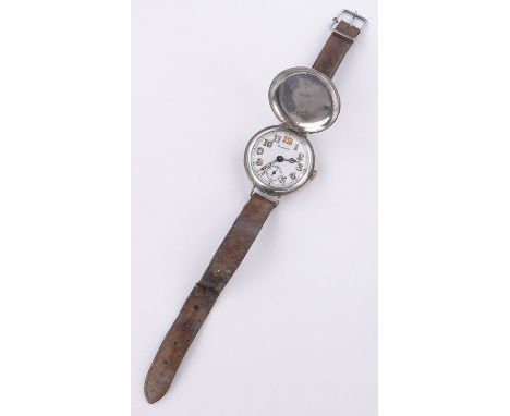 A Harrod's First War period silver cased military wristwatch,Swiss made with silver case and enamelled dial.