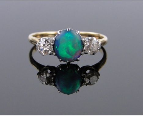 An 18ct gold 3 stone black opal and diamond ring,opal approx. 7mm x 6mm, size M.