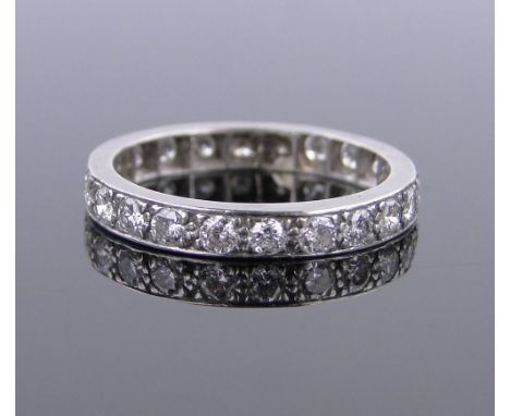 An unmarked white gold diamond eternity ring,total diamond content approx. 1ct, band width 3mm, size M.