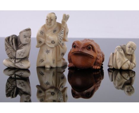 A carved ivory netsuke - a man with a large fish,height 2.1", and two other carved ivory netsukes and a carved wood frog nets